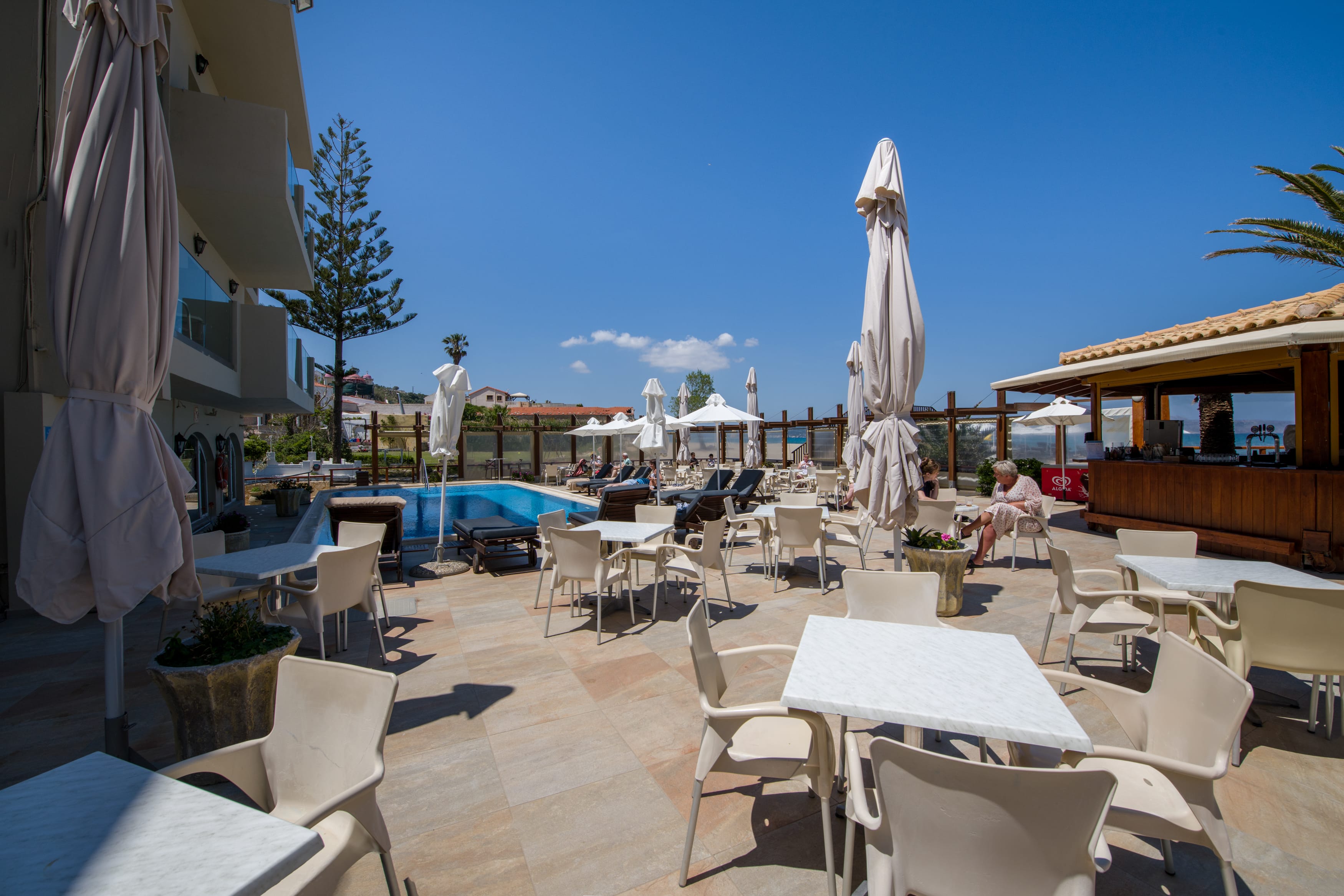 a patio with tables and chairs