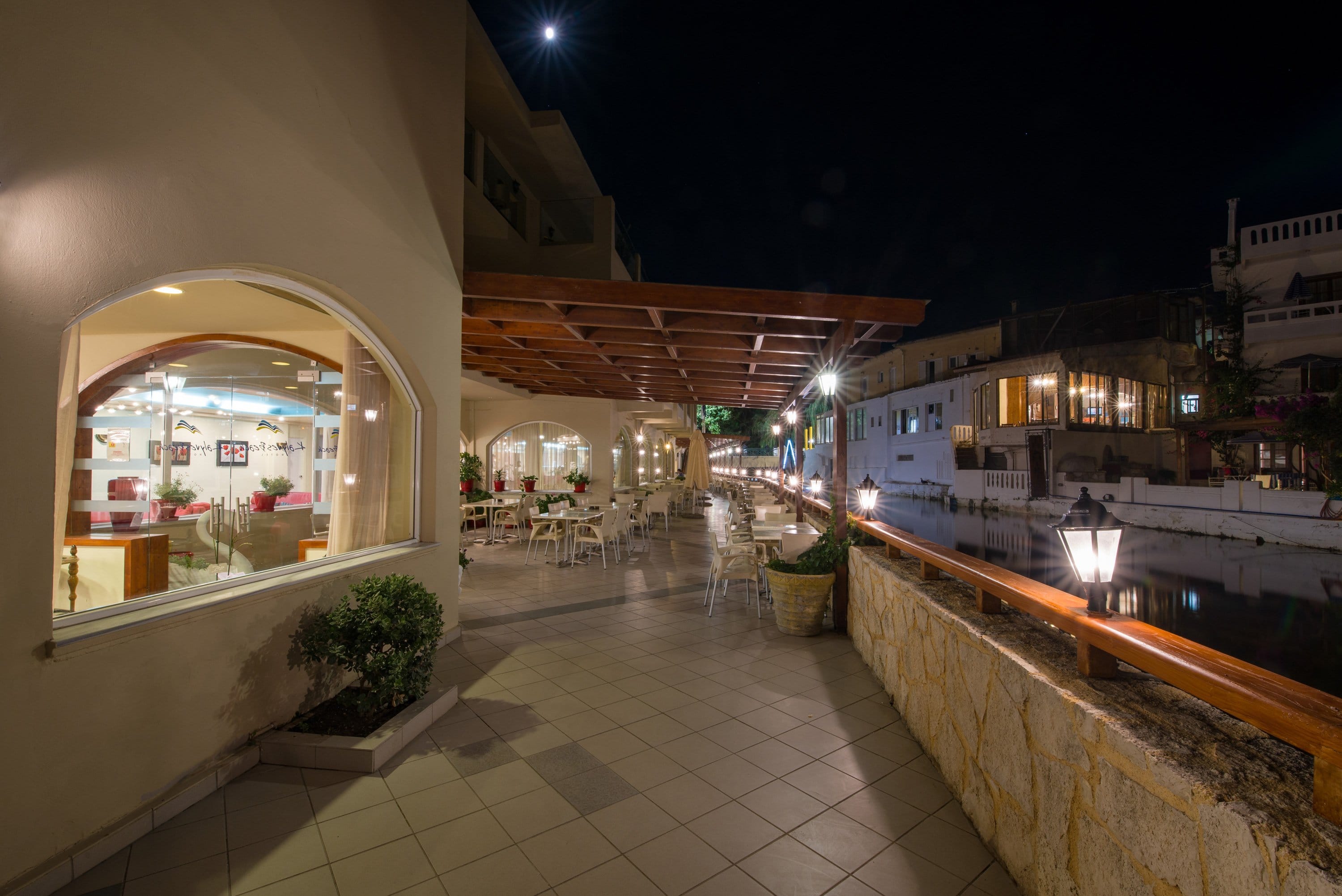 a walkway between buildings at night