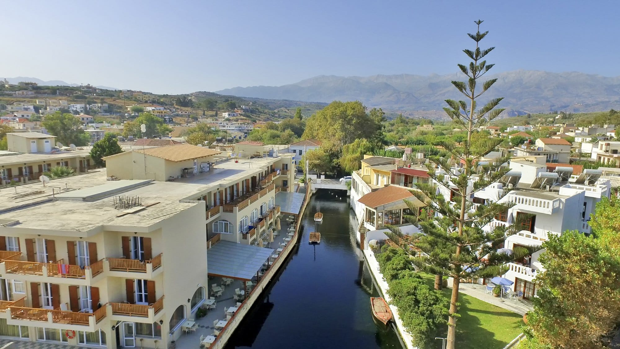 a river with buildings and trees