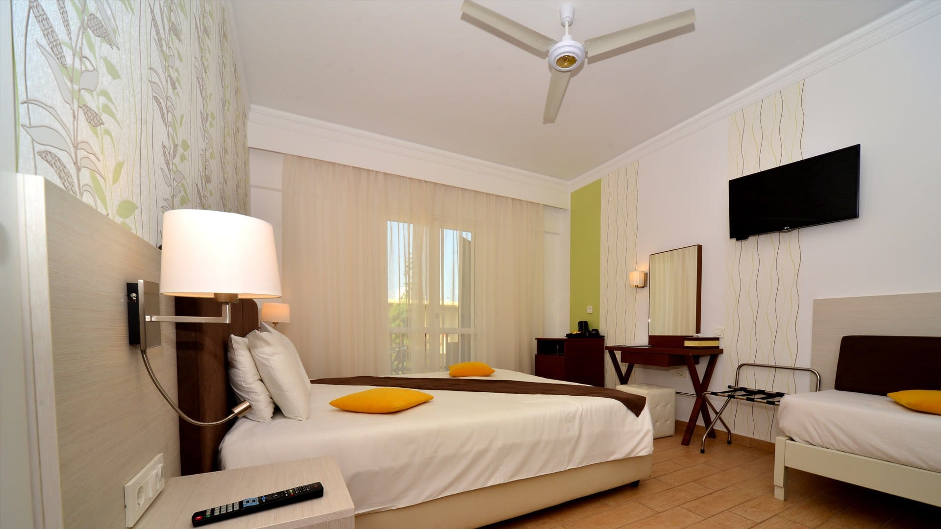 a bedroom with a bed and a tv