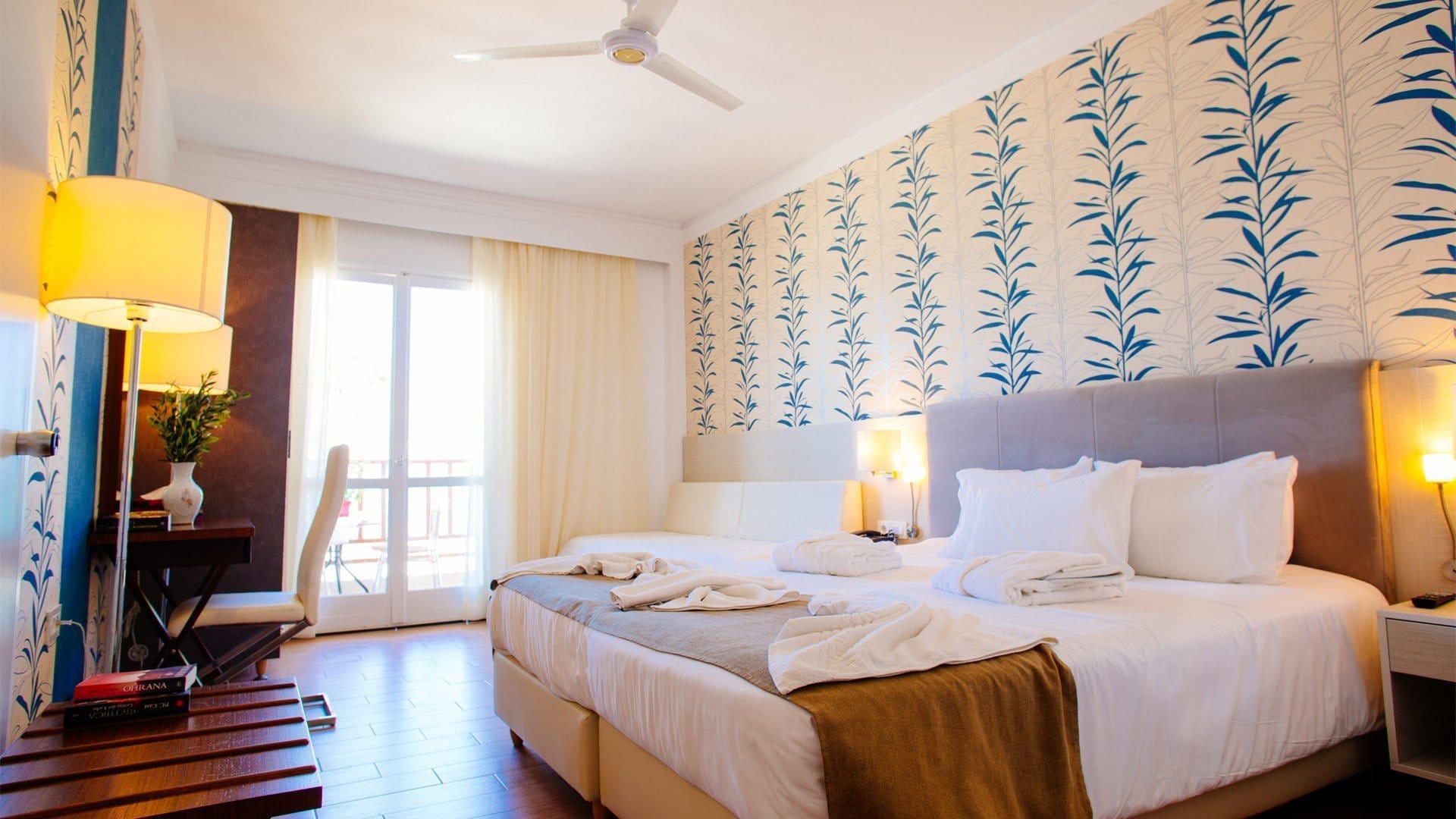 a bedroom with a bed and lamps