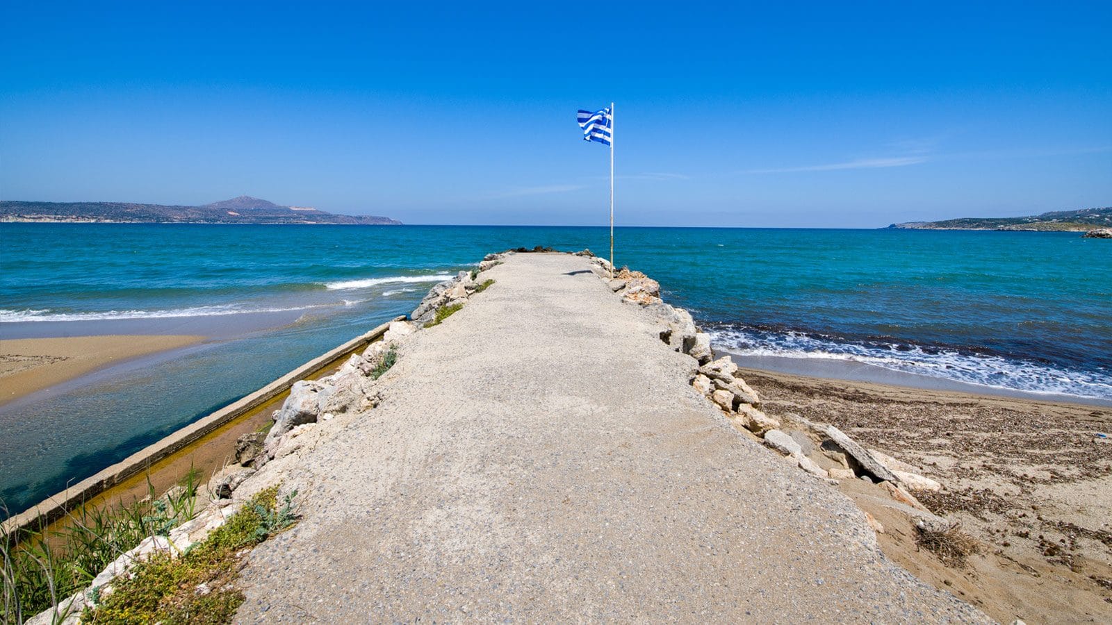 a sandy beach with a flag on it