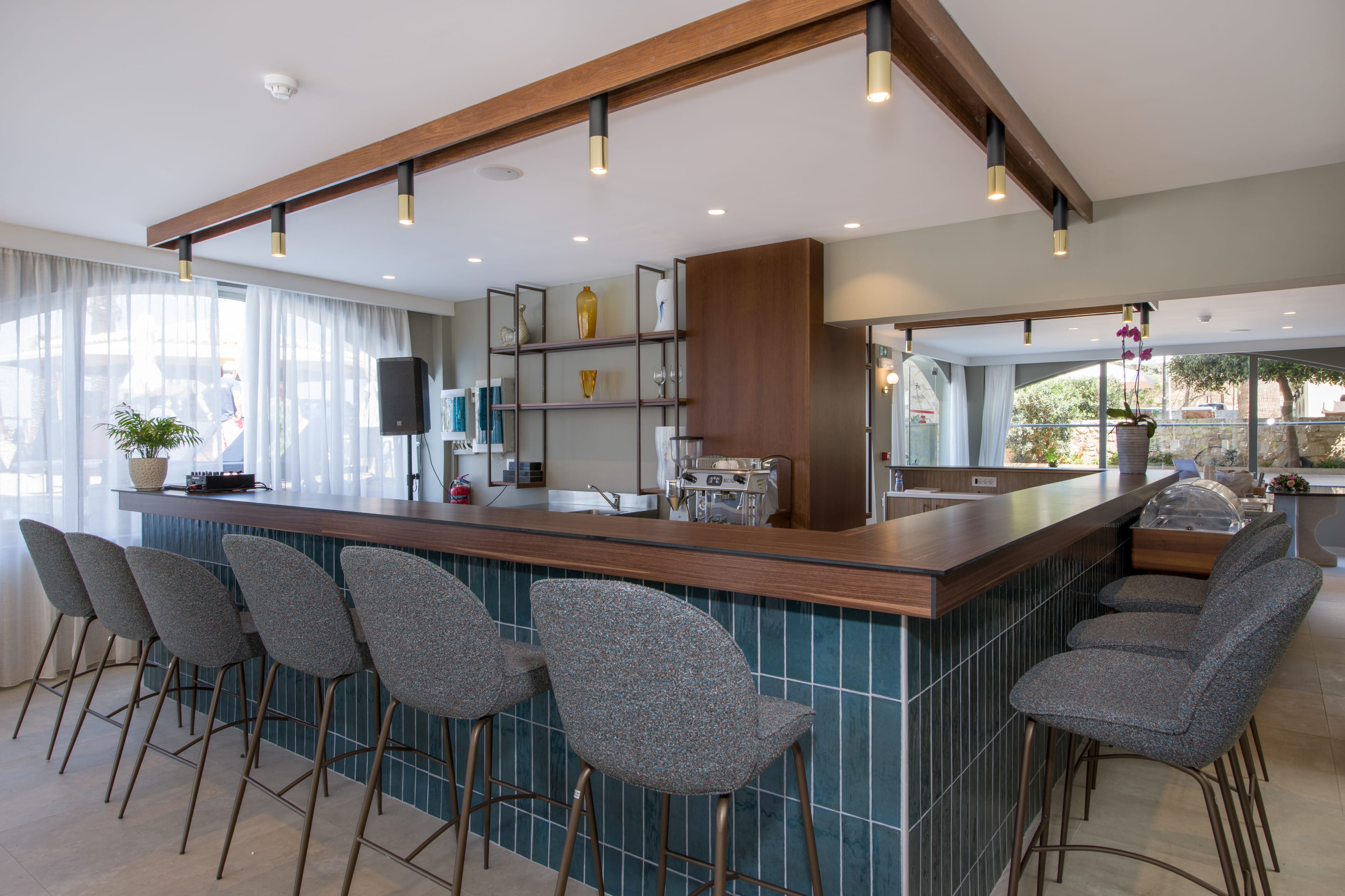 a kitchen with a bar and chairs