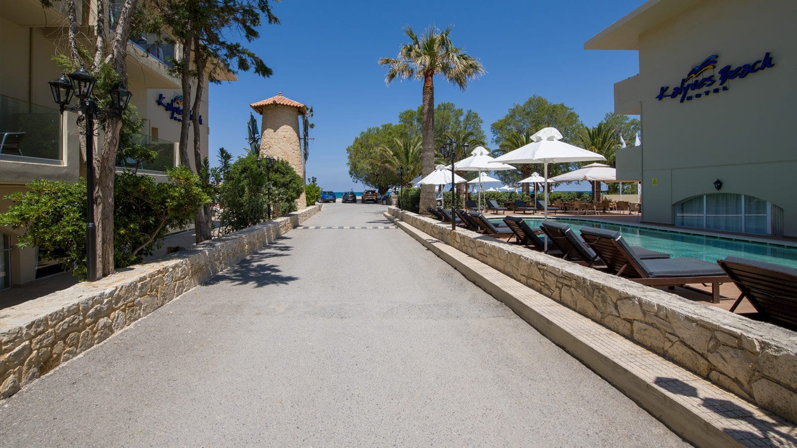 a walkway with trees and buildings