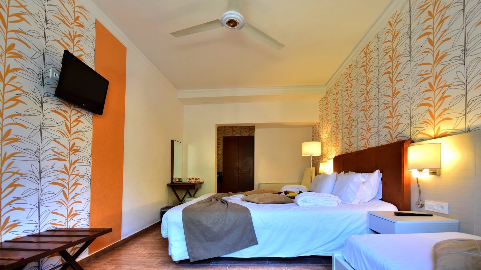a hotel room with a bed and a fan