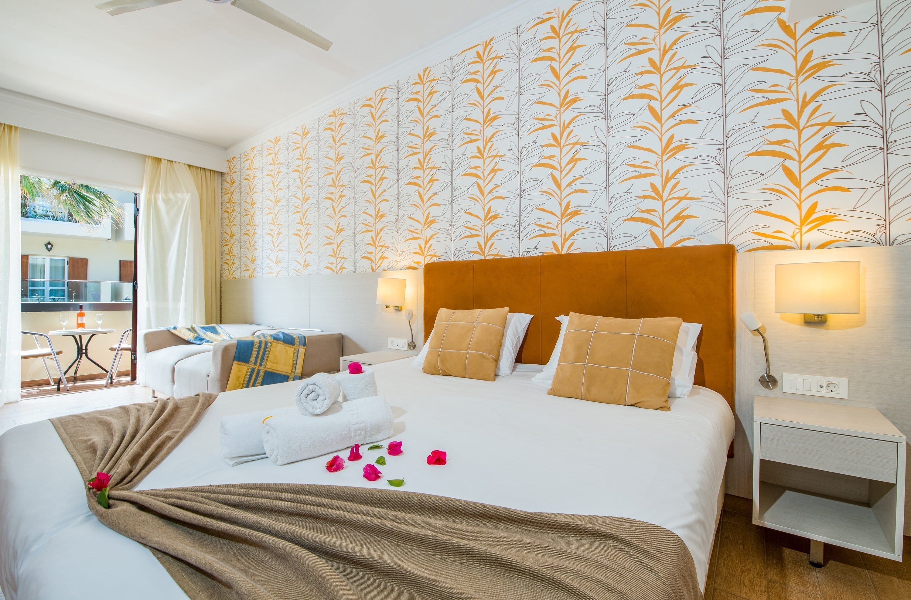 a bedroom with a bed and lamps