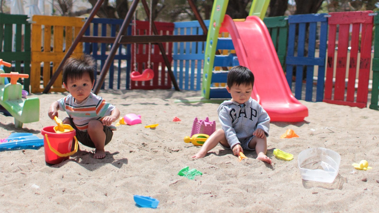 two kids playing in sand