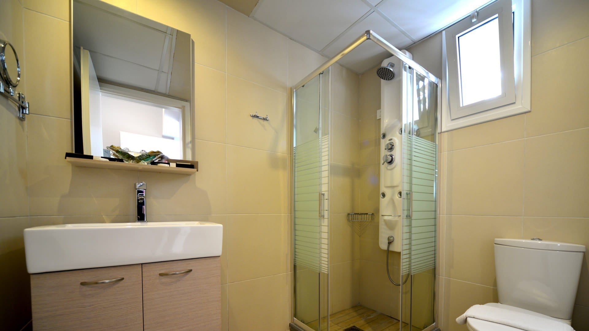 a bathroom with a shower unit and toilet