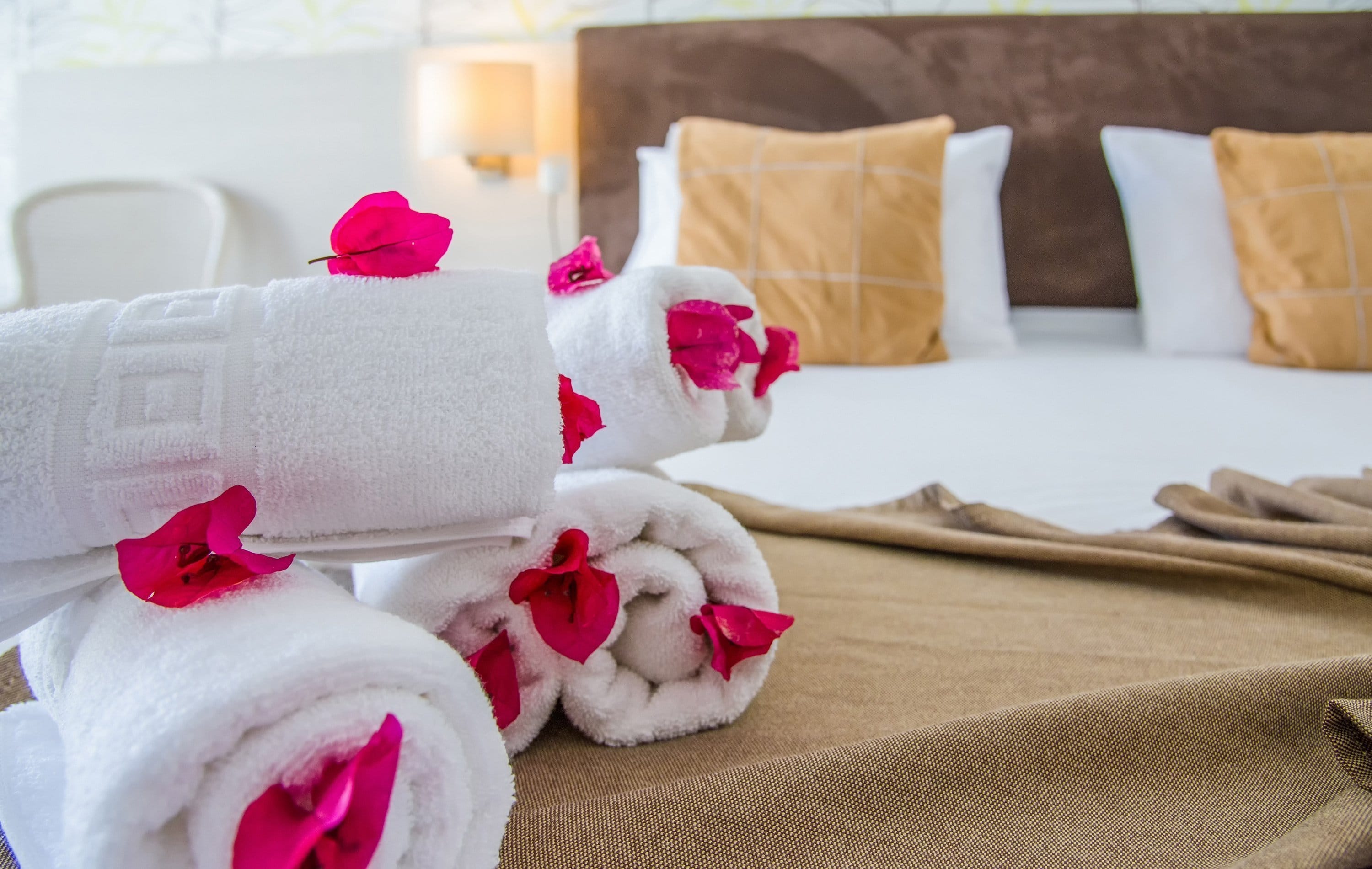 a group of white and red wrapped presents on a bed