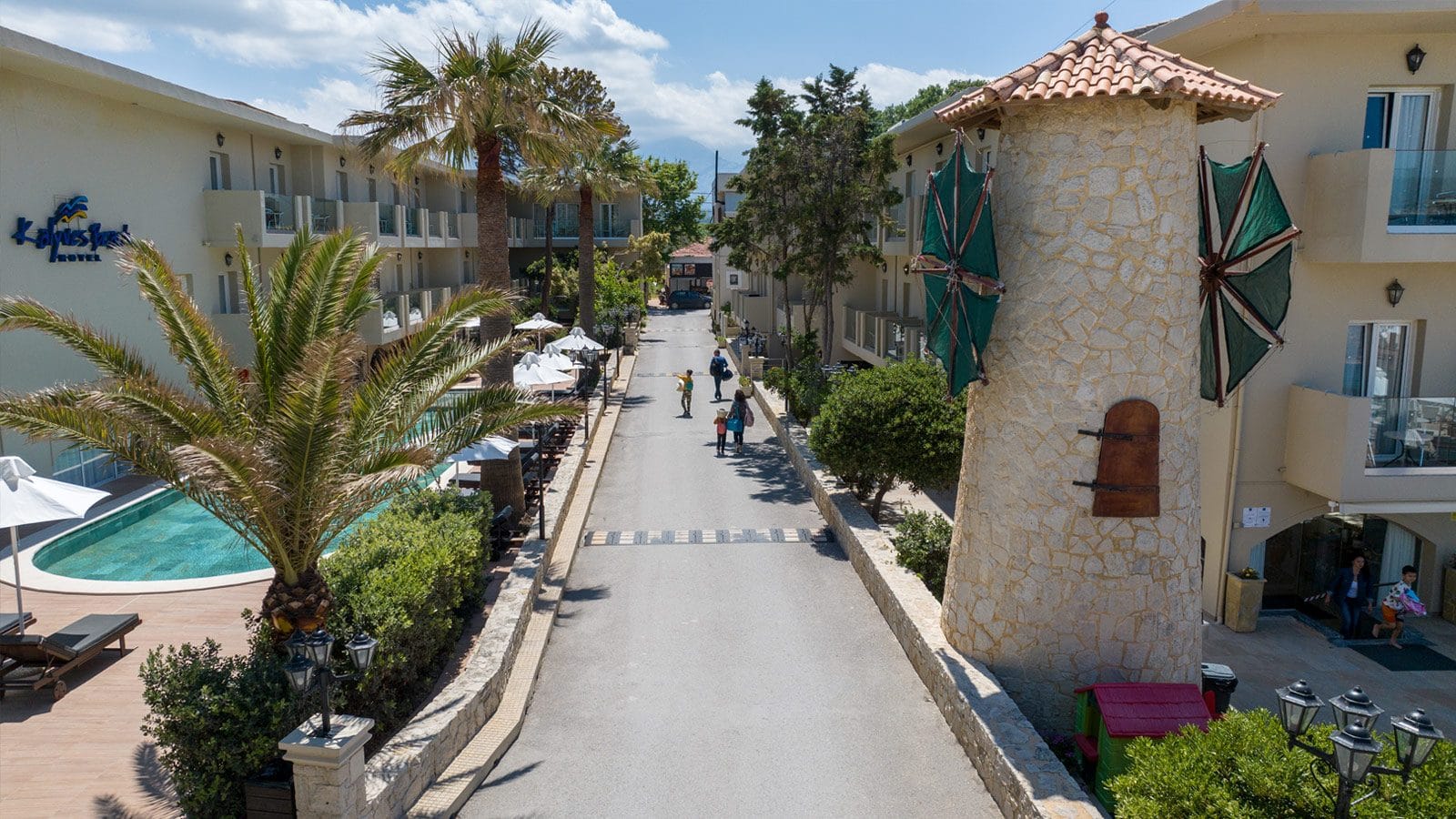 a street with palm trees and buildings