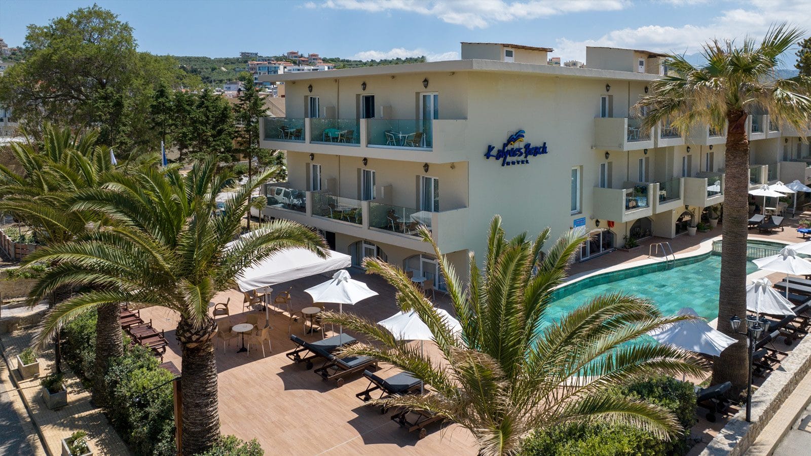 a building with a pool and palm trees