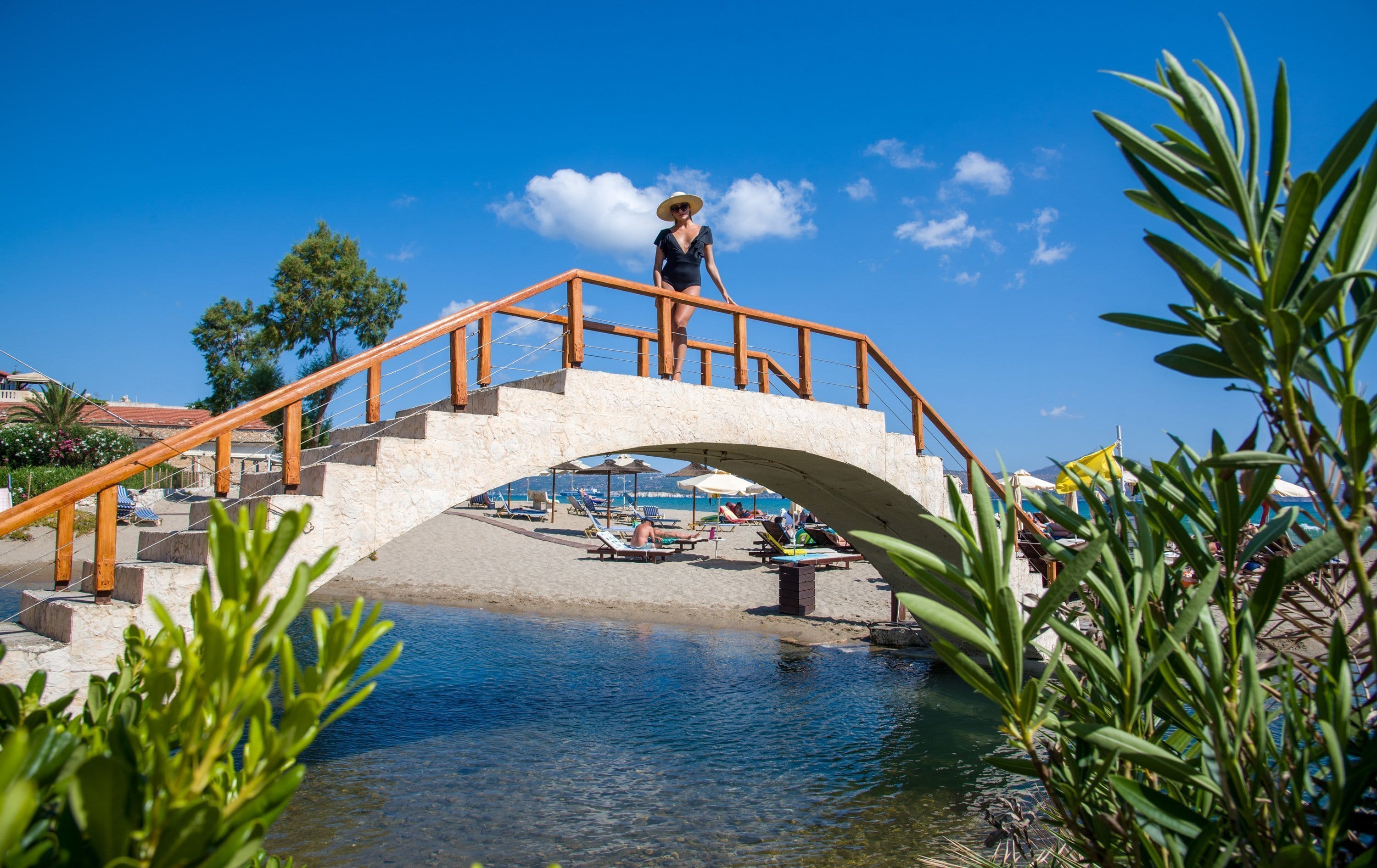 a person standing on a bridge over water