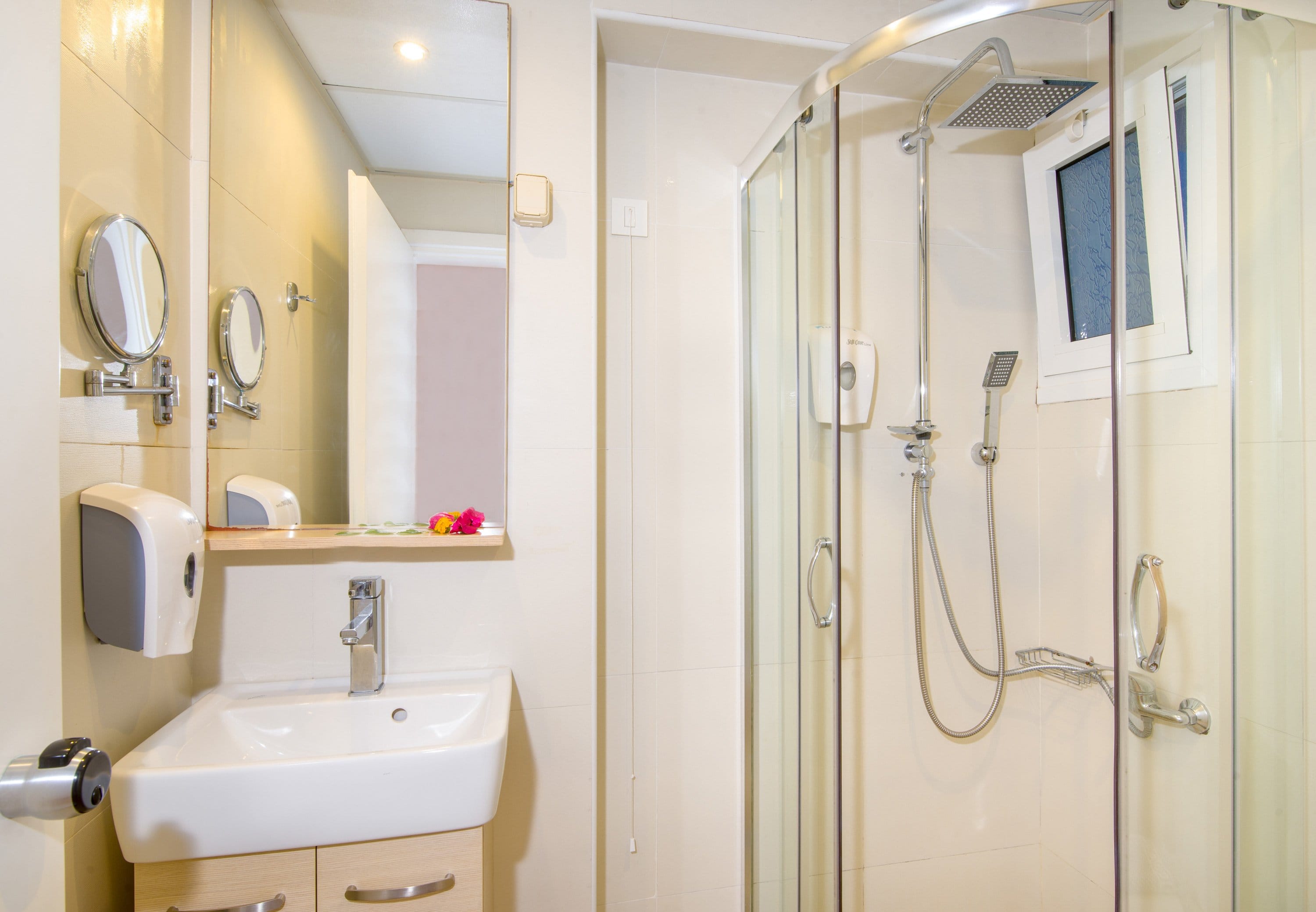 a bathroom with a shower unit and sink