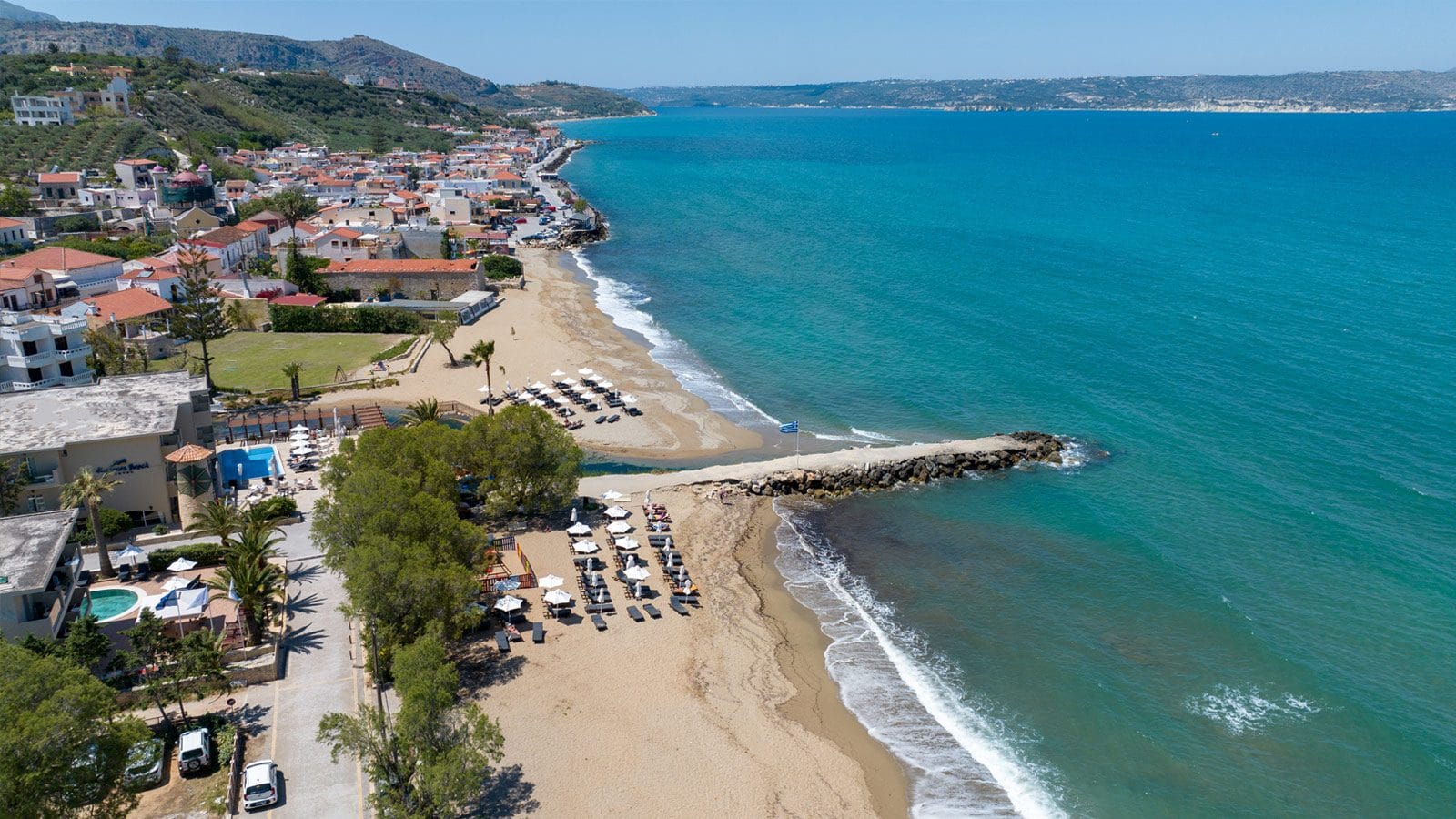 a beach with houses and trees