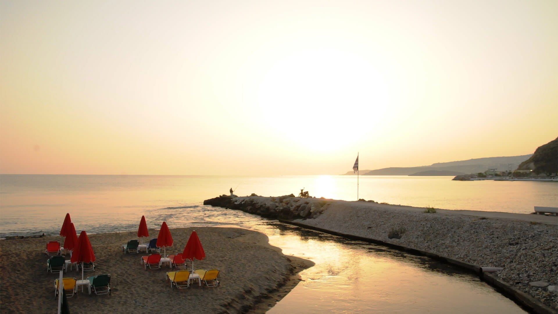 a beach with chairs and umbrellas