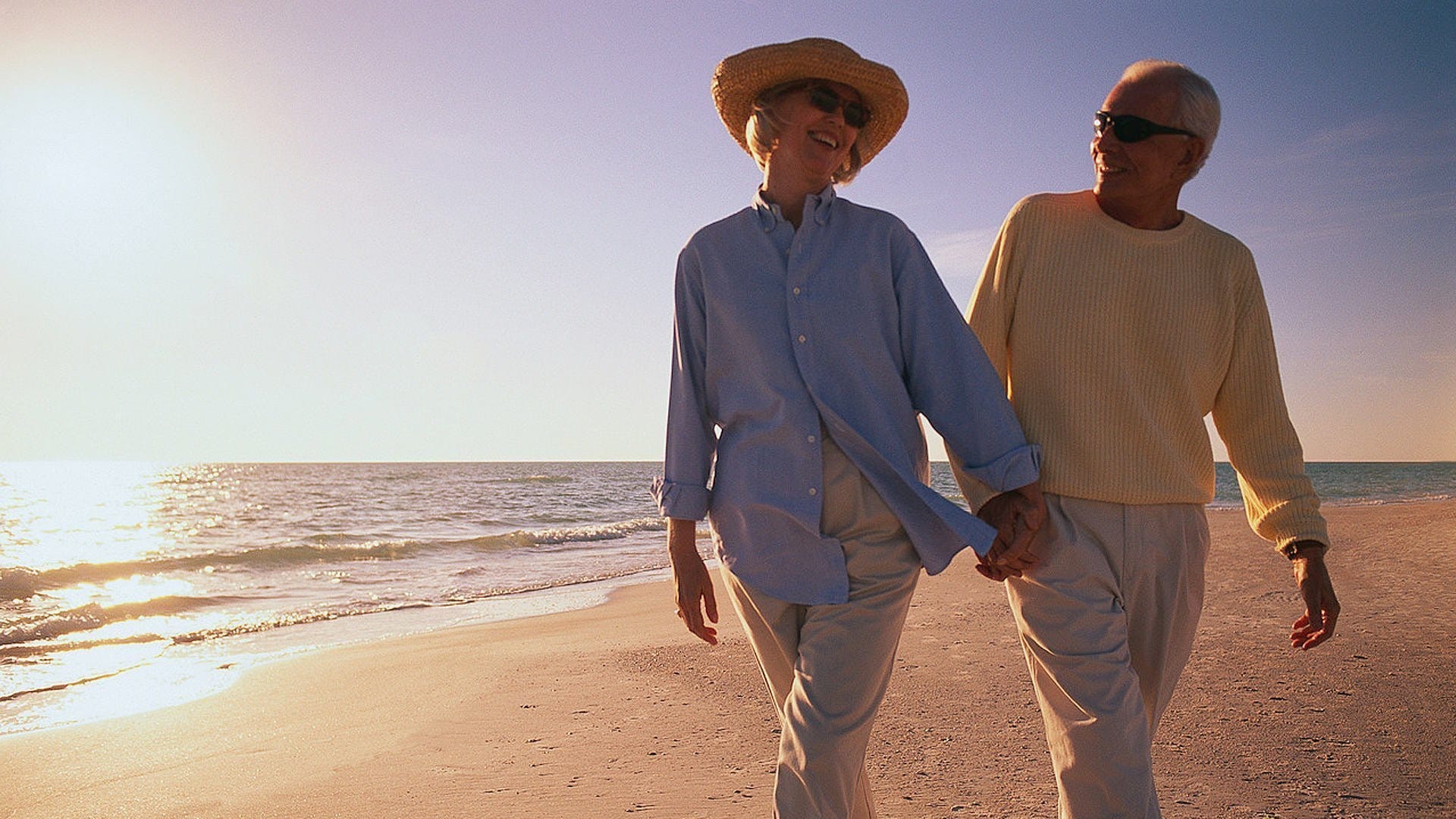 a couple of men walking on a beach
