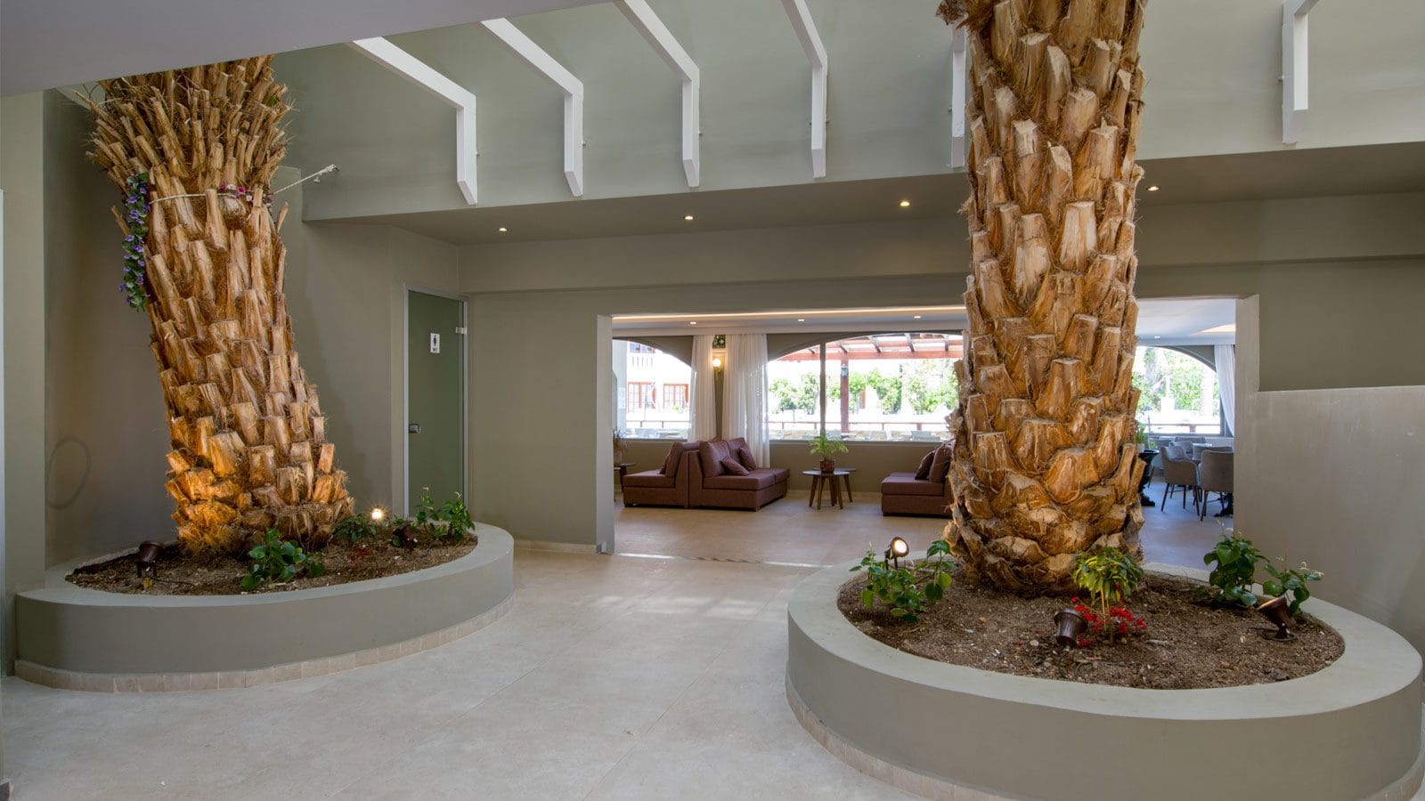 a room with a large planter and a large window