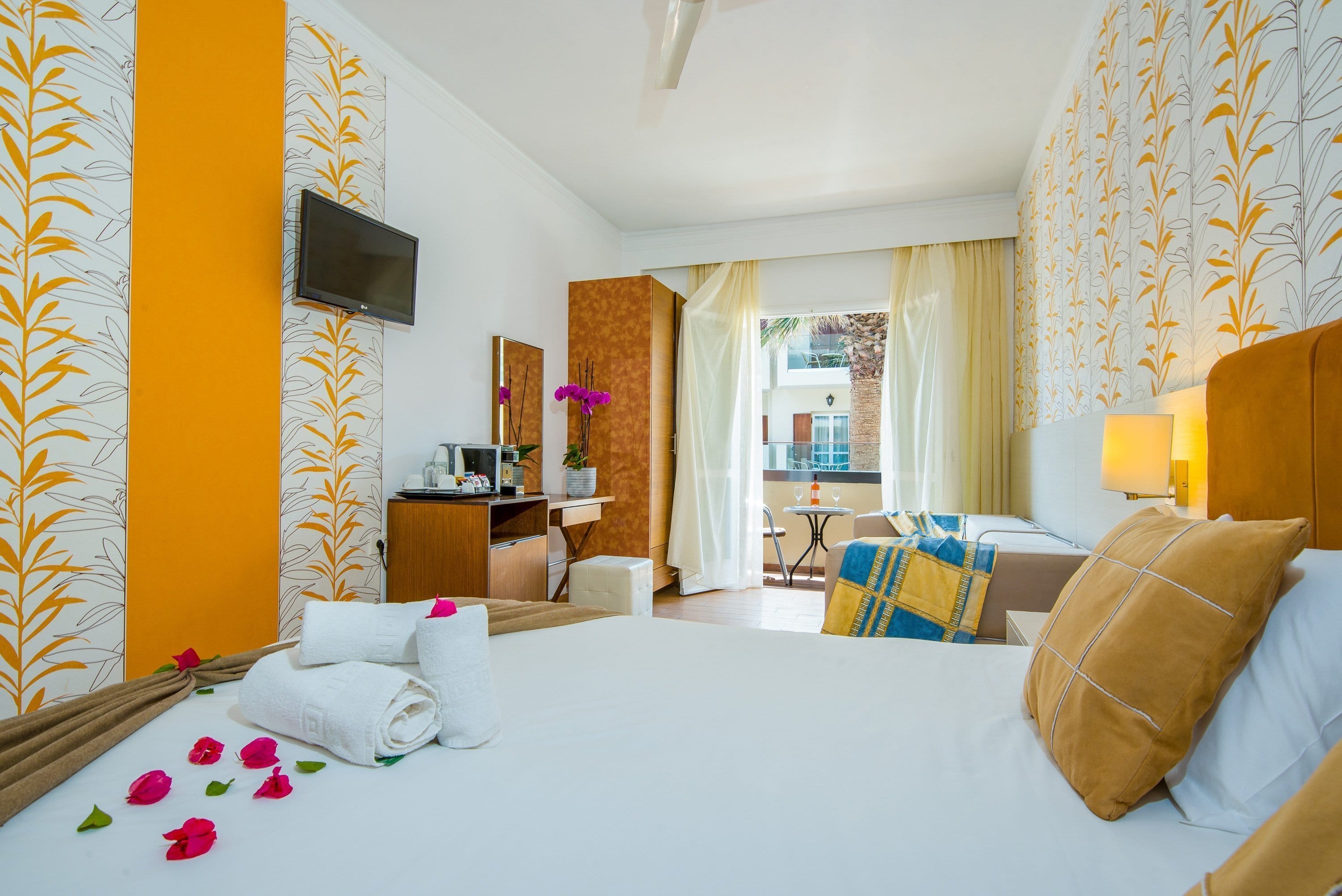 a bedroom with a bed and a tv
