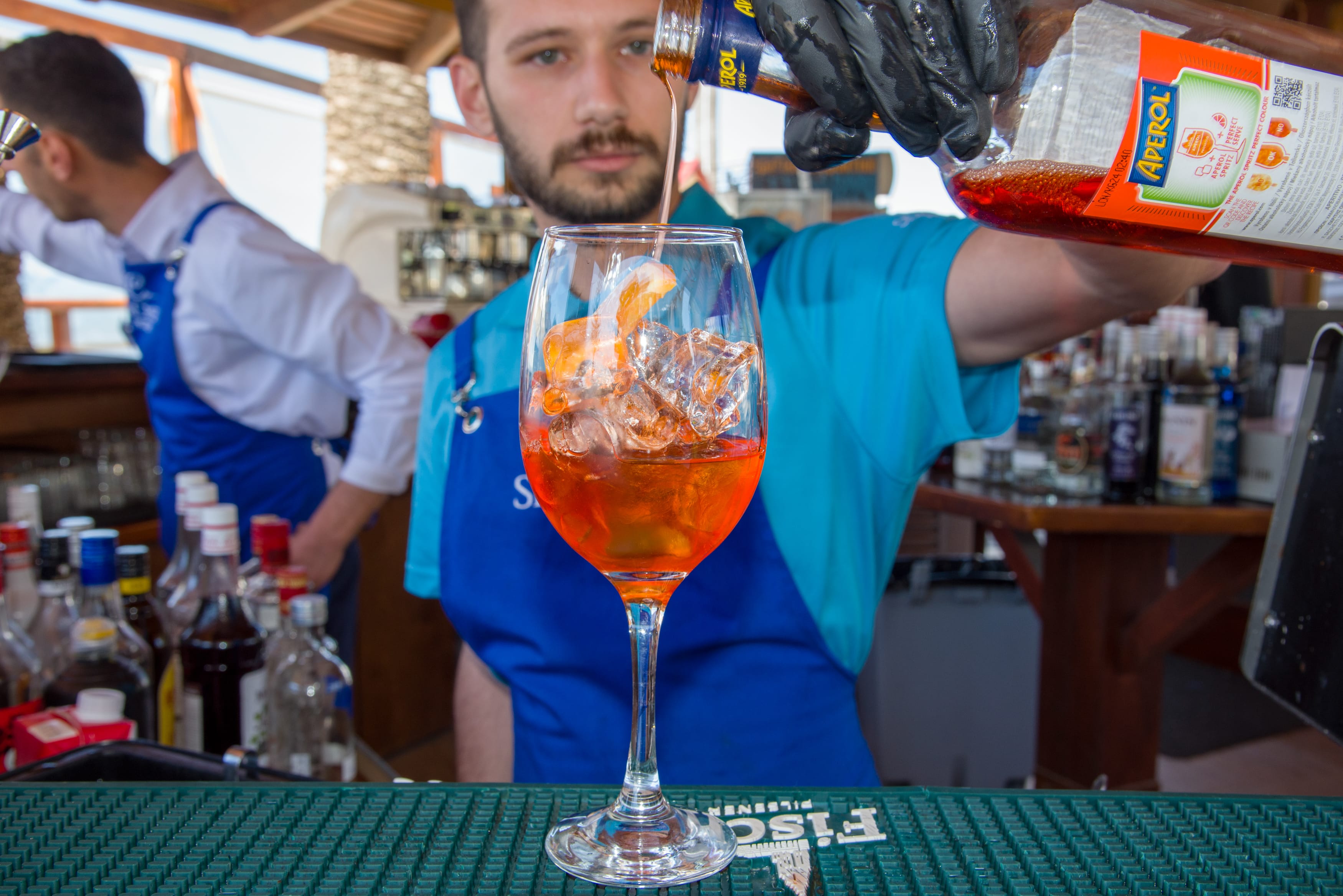 a person holding a glass of beer