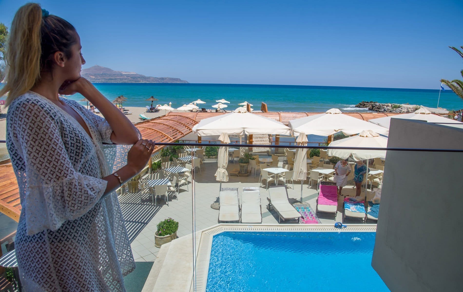 a woman standing next to a pool